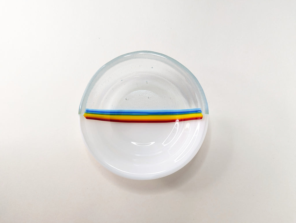 top view of white and clear dish with rainbow stripes in middle